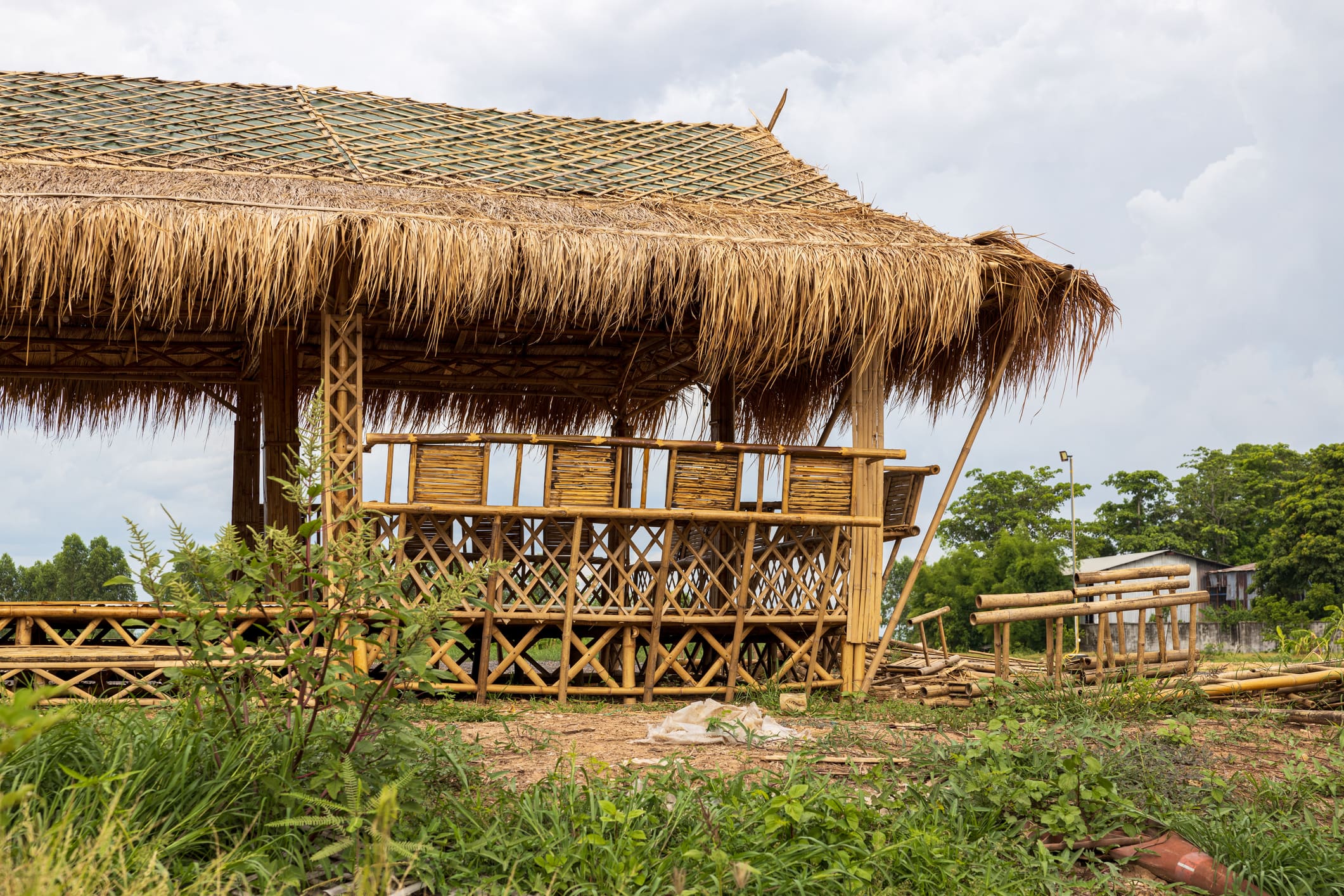 Thatched-roof bamboo hut with outdoor seating