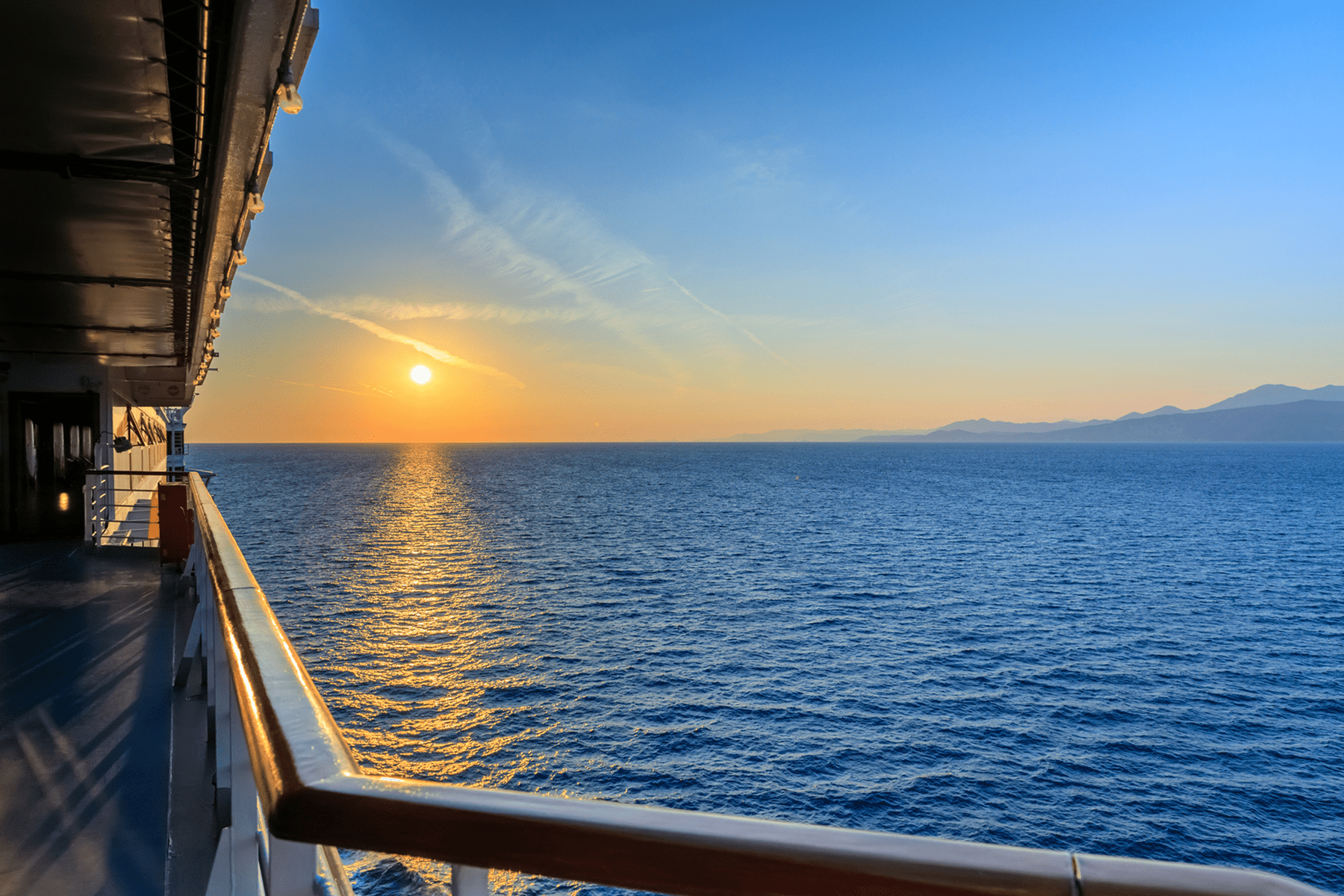 Sunset over ocean from cruise ship balcony