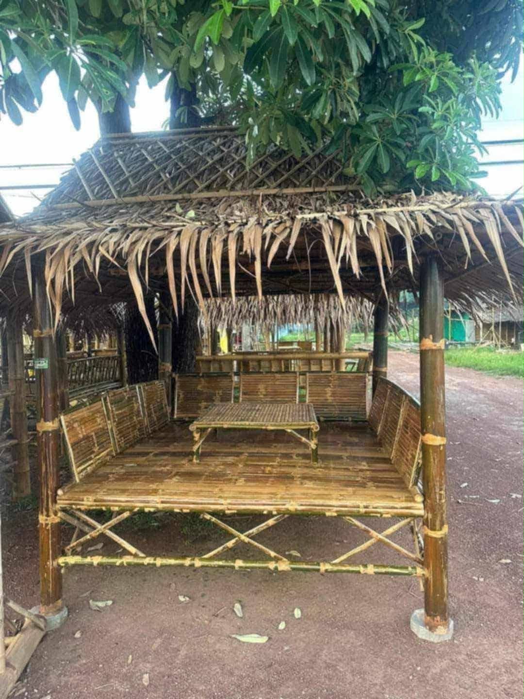 Thatched bamboo gazebo with bench and table