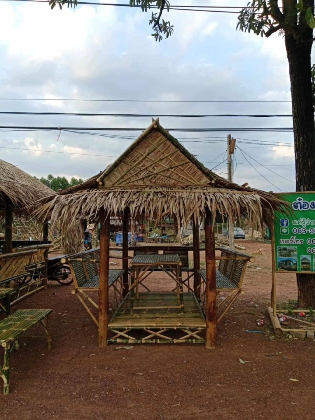 Thatched bamboo gazebo with benches outdoors