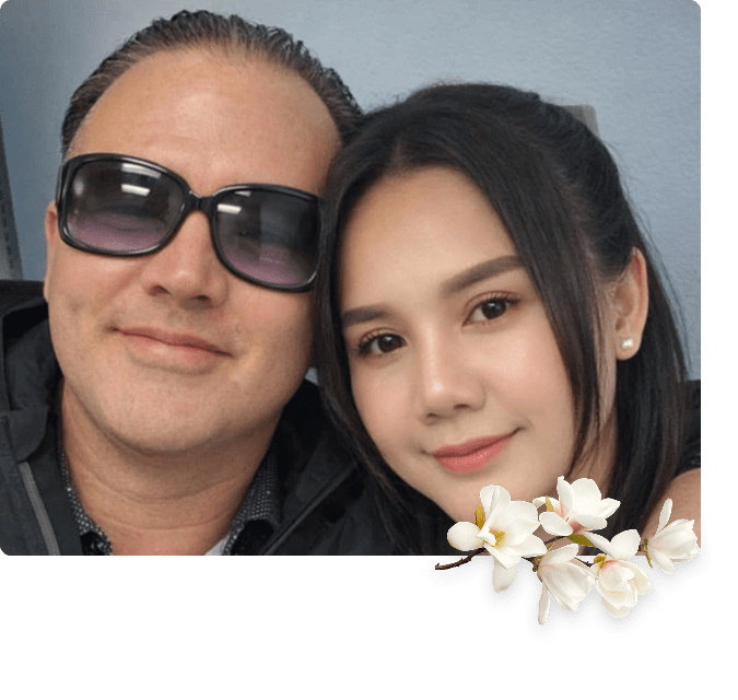 Smiling couple selfie with floral overlay