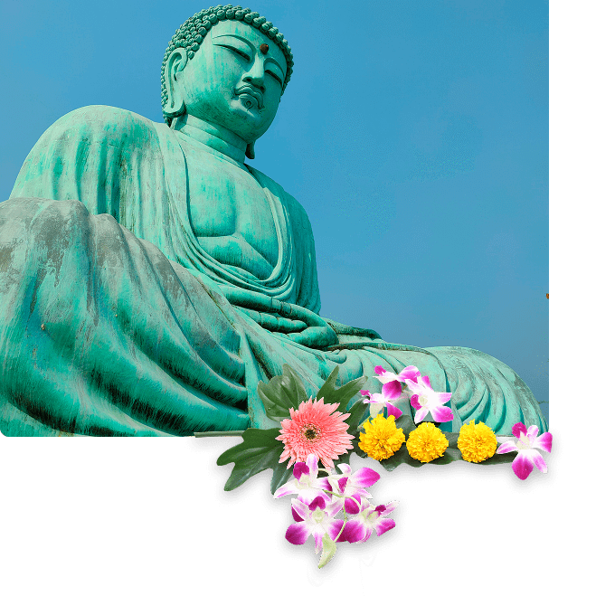 Large green Buddha statue with floral offerings